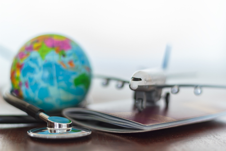 Healthcare and travel insurance concept. Stethoscope , passport document, airplane and globe