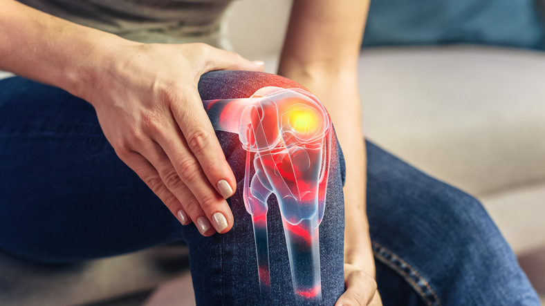Person holding knee. Depiction of inner knee structure over the picture.