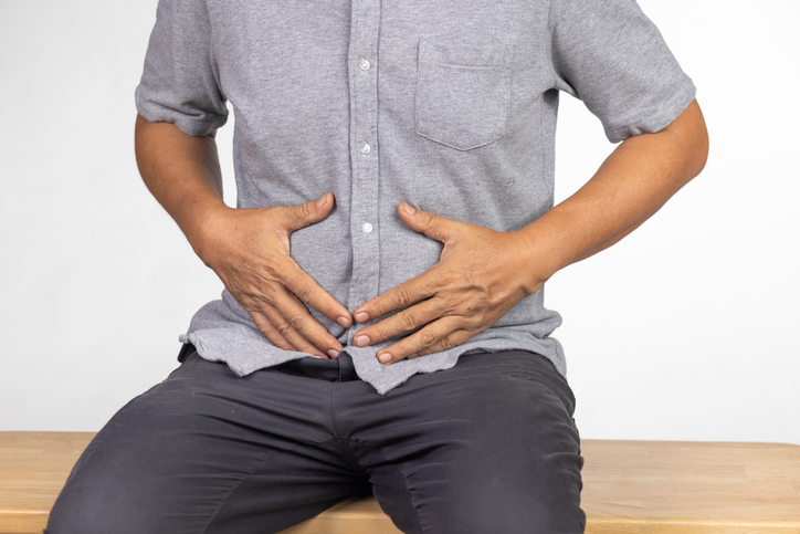Senior man felling stomach pain after meal.
